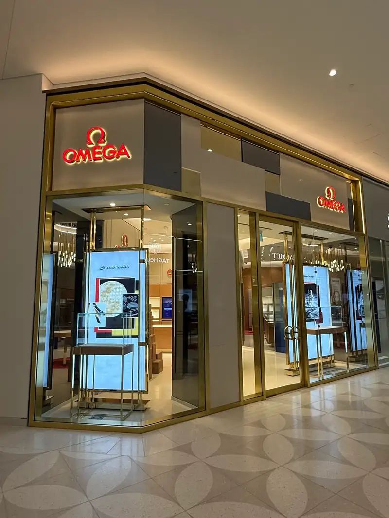 Luxury retail storefront glass with gold framing in a Vancouver shopping mall